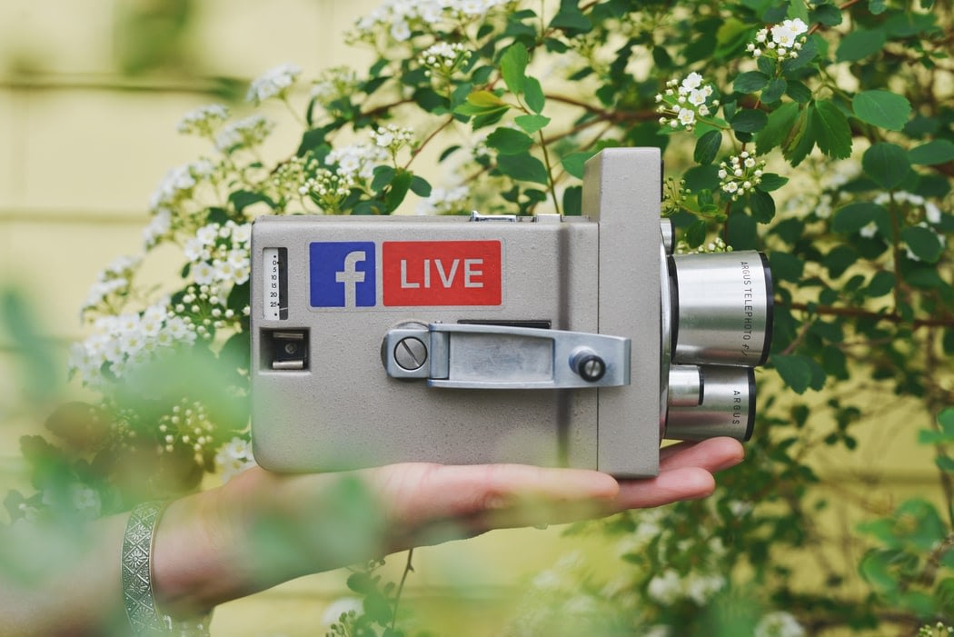 A small gray camera with the facebook live logo